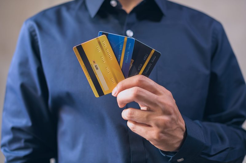 MoneyKey line of credit shown as a person holding multiple credit cards